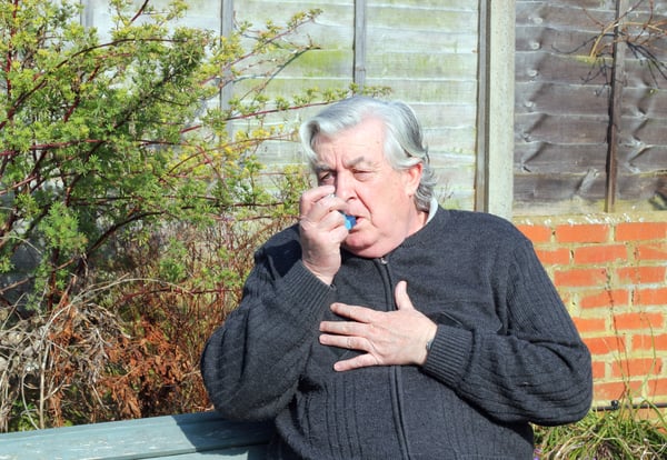 man using an inhaler
