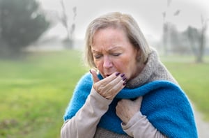 older woman coughing
